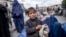 An Afghan boy and women beg outside a mosque in Kabul.