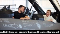 Президент Украины Владимир Зеленский и премьер-министр Дании Мэтте Фредериксен сидят в истребителе F-16 на авиабазе Скридструп в городе Военс, Дания, 20 августа 2023 года