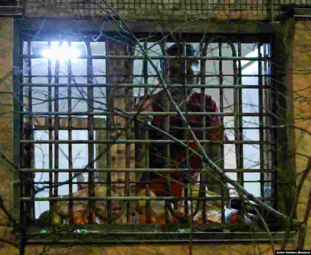 Navalny looks out of the window of his cell in Moscow in December 2011. He was sentenced to 15 days of detention for "resisting law enforcement officers." It was the first of what would later become regular occurrences. &nbsp;