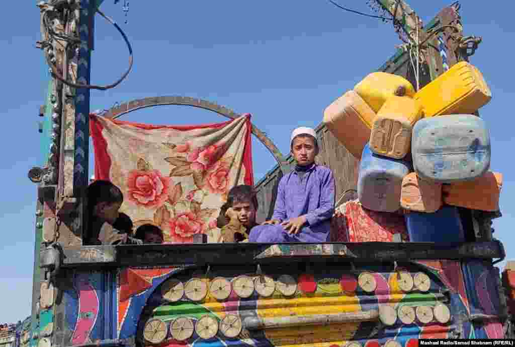 Young boys sit atop a truck that will carry them across the border at Chaman. Since ousting the Western-backed Afghan government and taking over the country in August 2021, the Taliban has placed restrictions on women's appearance, freedom of movement, right to work and study, and access to society.&nbsp;Restrictions have also been placed on the media, activists, and civil society organizations.