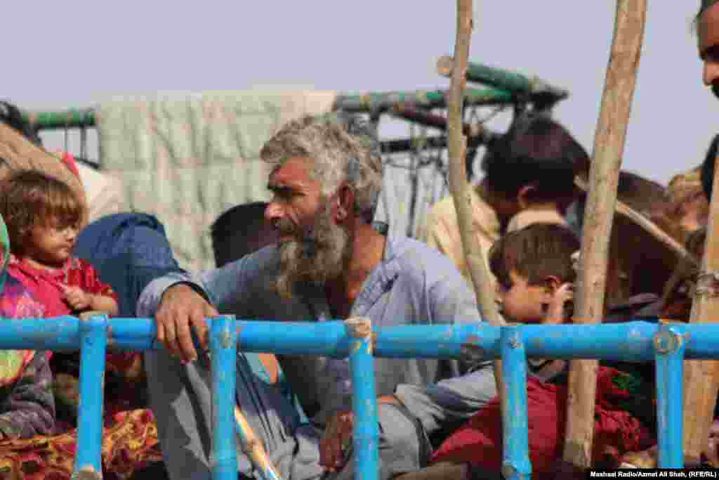 Afghan families crowd atop a truck before journeying into Afghanistan just hours before the expiration of the deadline.