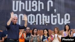 Armenia - Opposition mayoral candidate Andranik Tevanian (left) greets supporters during a campaign rally in Yerevan, August 23, 2023.