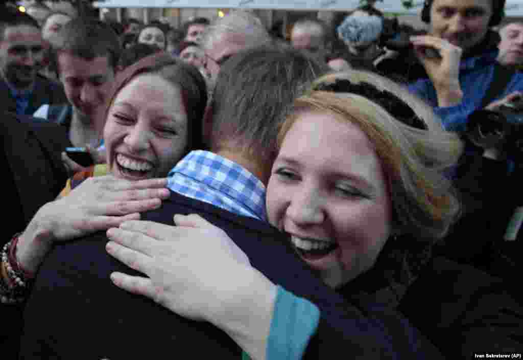 Jubilant supporters embrace Navalny in May 2012 after he and left-wing politician Sergei Udaltsov were released from detention after serving a 15-day sentence for "participating in an illegal public event" in Moscow. The two were arrested as they protested Putin's inauguration.