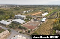 The H. Navasardian Secondary School in Amberd. The school’s grapevines are visible on the right. Strawberries are grown in the greenhouse in the upper right, while small orchards grow around the school’s main building on the left.