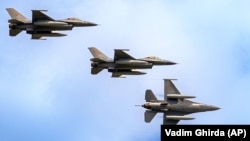 Avioane de luptă F-16 ale Forțelor Aeriene Române efectuează un survol la expoziția internațională Black Sea Defence and Aerospace (BSDA) din București, România, 22 mai 2024.