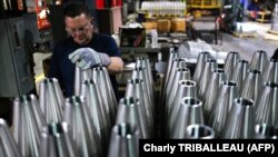 An employee handles 155 mm caliber shells after the manufacturing process at the Scranton Army Ammunition Plant (SCAAP) in Scranton, Pennsylvania on April 16, 2024