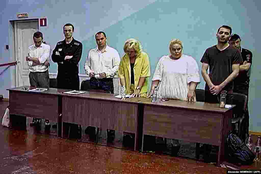 Aleksei Navalny (second from left) listens as the guilty verdict against him is read out on August 4, 2023. He was&nbsp;sentenced to 19 years&nbsp;in Russia's harshest prison regime. He was convicted under six articles of the Criminal Code, including creating and financing an extremist community, calling for extremism, rehabilitating Nazism, and involving minors in dangerous acts.