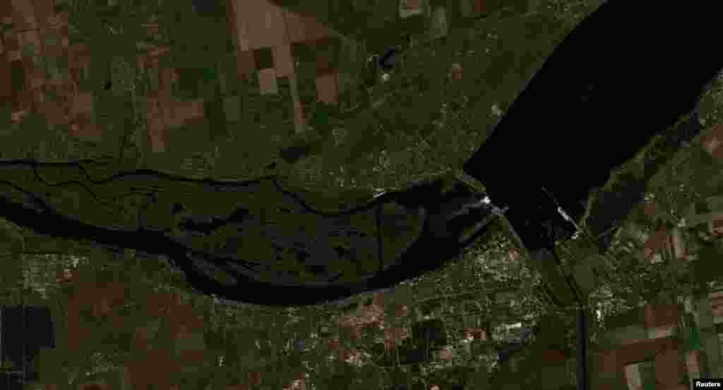 A satellite image shows the Nova Kakhovka dam and the surrounding Kherson region on October 18, 2022. Worst-case modelling following the destruction of the dam predicted that flooding would take place on the left (southeast) side of the river bank. A 4-to-5-meter wave would hit the Antonivskiy Bridge east of Kherson city about 19 hours later, there would be a back swell flooding up the Inhulets River, and after four or five days there would be some flooding up the Bug River to Mykolayiv.&nbsp;