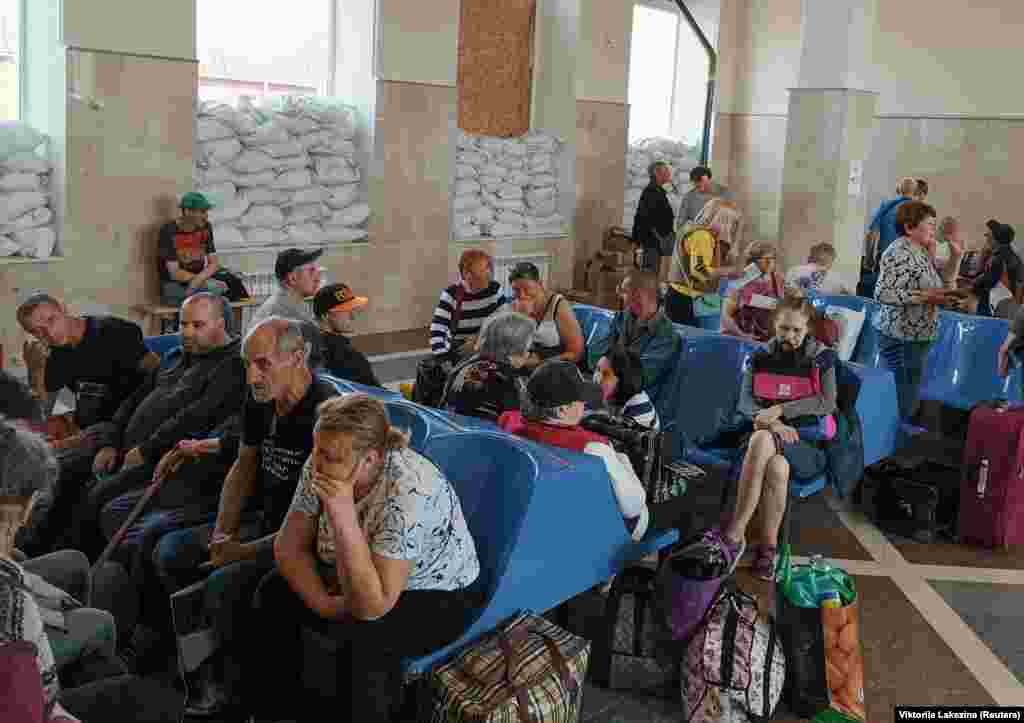 Residents wait for an evacuation train at the railway station in Kherson. Russia said Ukraine had carried out "deliberate sabotage" on the dam at Nova Kakhovka. It was not possible to independently verify what happened. &nbsp;