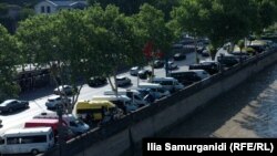 თბილისი, მტკვრის სანაპირო: ტროტუარებზე „ქართული ოცნების“ აქციაზე ჩამოყვანილი ტრანსპორტია გაჩერებული.