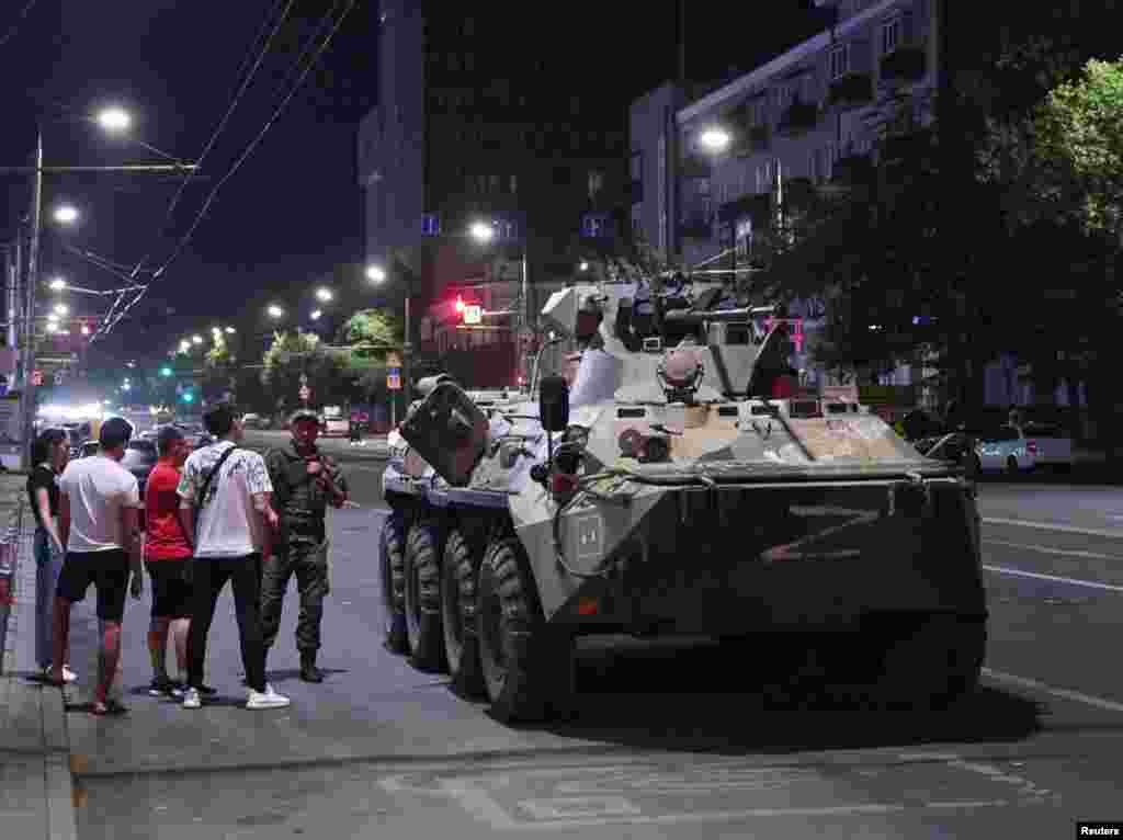 An image made before dawn on June 24 showing civilians in Rostov-on-Don gathered around an armored vehicle marked with the letter Z associated with Russia's invasion of Ukraine.&nbsp;