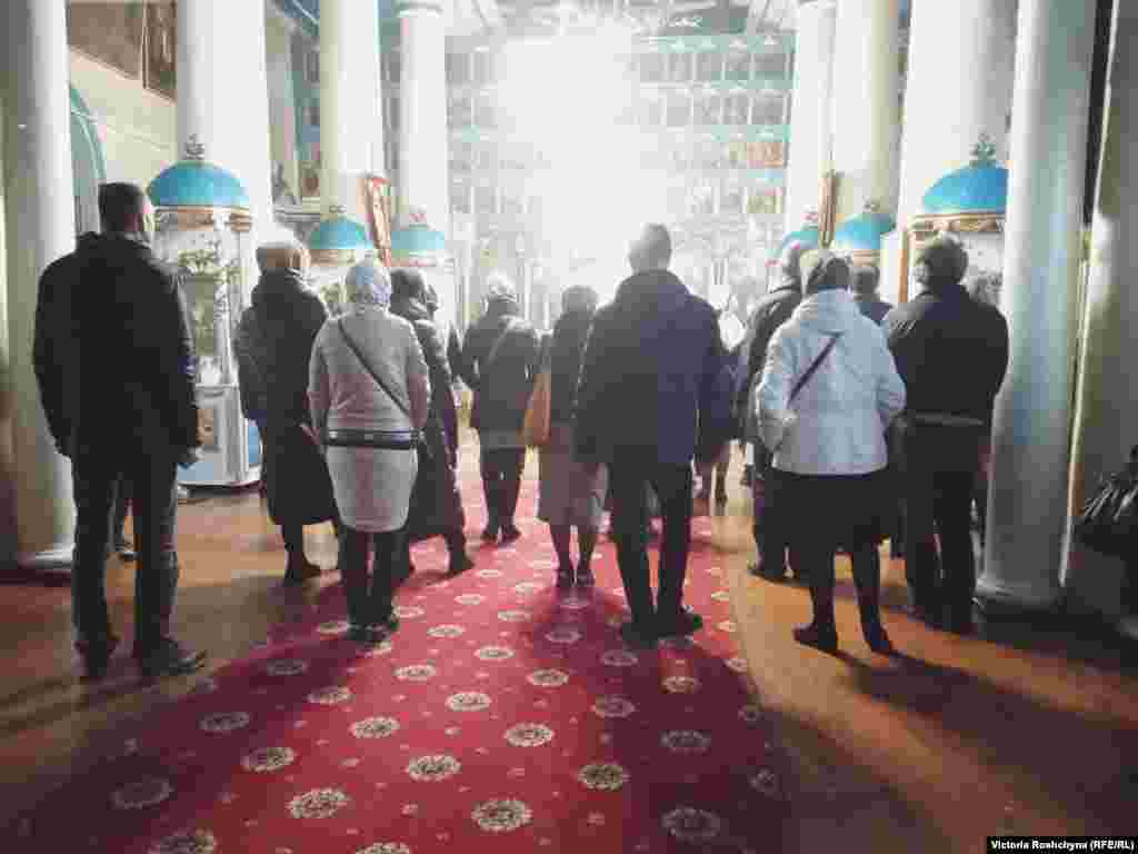 People attend a church service in occupied Kherson. "We pray. We do our jobs. Of course, we want Ukraine to be here," said a local clergymen.&nbsp;"I also have a family. They also cry. But I try to avoid politics."