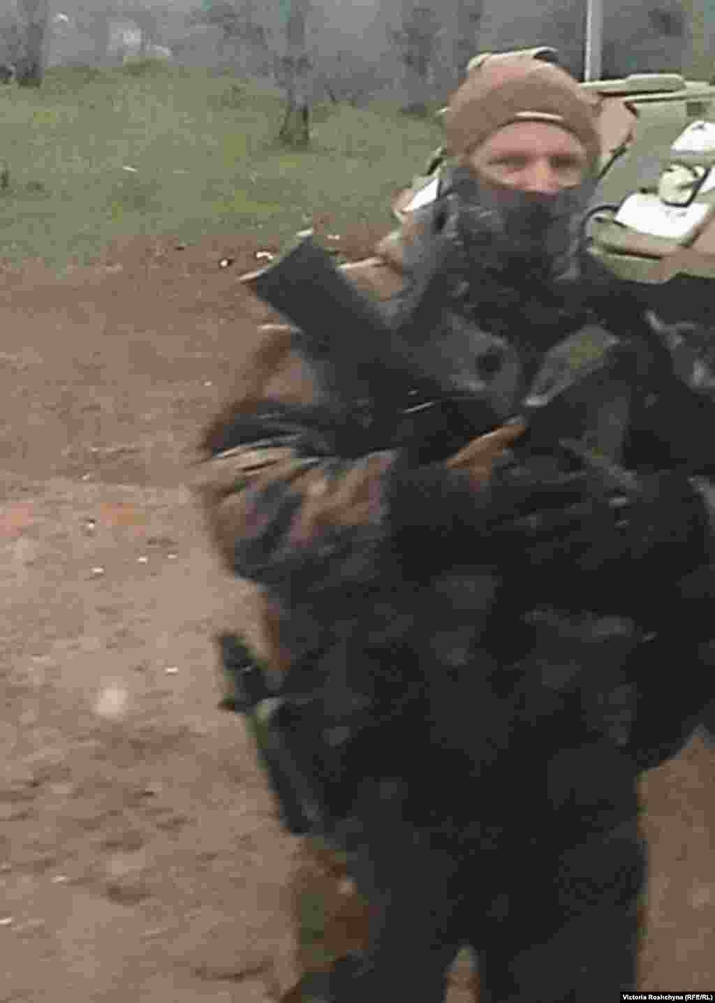 A Russian servicemen outside one of the occupied villages near Kherson.&nbsp; "We are from Donetsk. How do you feel about May 9?" one soldier asked RFE/RL at a checkpoint, referring to the date on which Russia commemorates Victory Day over Nazi Germany. After checking documents, those manning checkpoints often ask for cigarettes.​