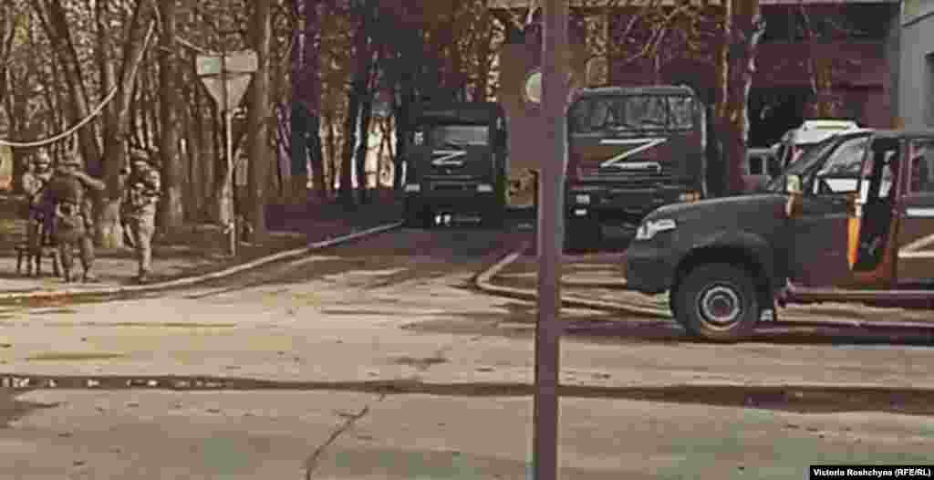 Russian troops patrol near the Kherson Regional State Administration. "All thinking Kherson residents are for Ukraine, of course," one local resident told RFE/RL. "But now there is some uncertainty -- and this gives rise to fear. You don't know what will happen tomorrow."