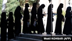 Gratë afgane qëndrojnë në radhë para Universitetit të Kabulit për t'iu nënshtruar testit pranues për në universitet. 13 tetor 2022.