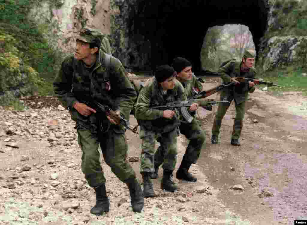 Bosnian Serb soldiers patrol a mountain road to prevent Bosnian troops from breaking through to Sarajevo on April 17, 1994.