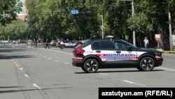 Armenia - Police cars parked on Yerevan's Marshal Bagramian Avenue blocked by relatives of missing soldiers, June 19, 2025. 