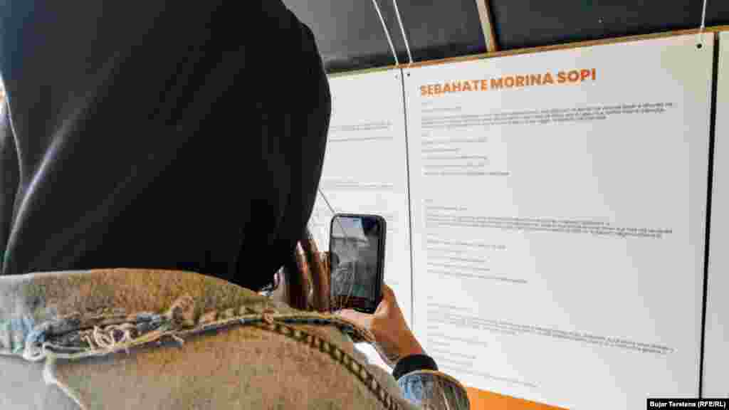 Një grua duke fotografuar emrat e grave të vrara.