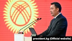 Президент Садыр Жапаров на фоне изображения флага Кыргызстана. Бишкек. 30 сентября 2021 года.