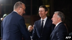 German Chancellor Friedrich Merz (L) greets the US President's son-in-law Jared Kushner and US special envoy Steve Witkoff (R) upon their arrival on December 15, 2025 at the Chancellery in Berlin, Germany, where European leaders as well as the Ukrainian President, US President's envoy, and heads of the NATO meet for talks on how to end the grinding war of Russia with Ukraine.