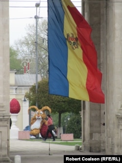 A woman walks past an Easter bunny adorning Chisinau's Cathedral Park.