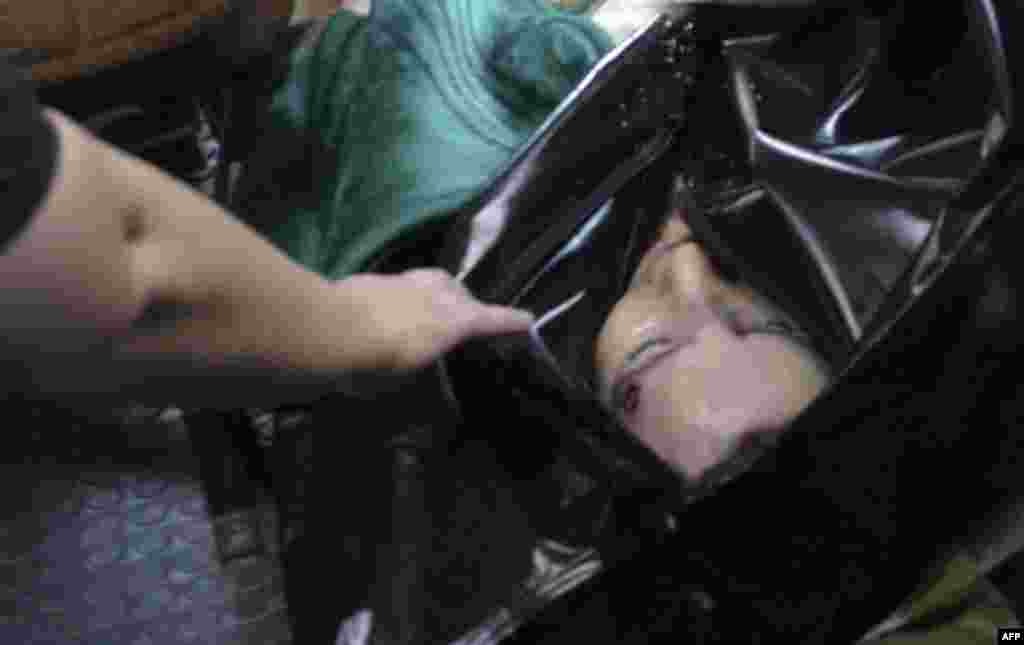 The body of slain Russian human rights activist Natalya Estemirova is transported to the village of Koshkeldy, Chechnya, for her funeral on July 16, 2009.