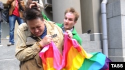 A man (right) attacks a gay rights activist in central Moscow. Antigay attitudes are still quite prevalent in much of Russia. 
