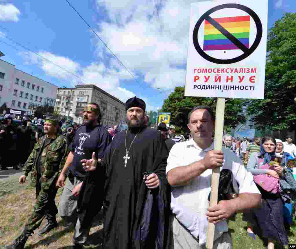 Orthodox believers carry a placard saying "Homosexuality destroys family values" during a counterdemonstration.&nbsp;