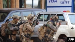 Франци -- ЖихIадхоша тIелатар динчу дийнахь, францойн полици, Париж,18Деч2016
French special forces take position in the surroundings of the Splendid hotel following an attack by Al-Qaeda linked gunmen on January 16, 2016 in Ouagadougou. 