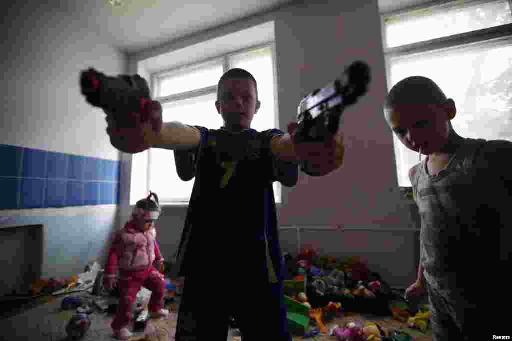 Children of families who have fled from fighting in Slovyansk play with toys at temporary accommodation in a dormitory in the eastern town of Ilovaysk on June 3.