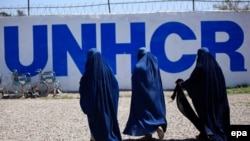 Afghan burqa-clad women arrive to get registered during United Nation High Commissioner for Refugees (UNHCR) voluntary return program in Chamkani, on the outskirts of Peshawar on April 3.