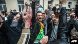 Pro-Russia militants, who had been detained during an attack on a Ukrainian unity rally on May 2, react after being freed following the storming of a police station in Odesa on May 4. 