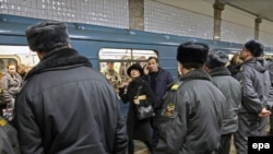 Police guard a metro station in Moscow a day after the deadly bombings. Kyiv wants to step up its security to prevent similar attacks.