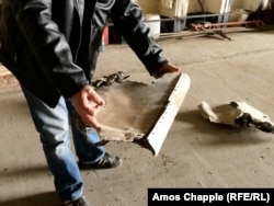 Сябра Мілавіцкага аэраклюбу трымае ў руках кавалкі савецкага зьнішчальніка, які, паводле ягоных словаў, падарвалі выбухоўкай падчас сыходу савецкіх вайскоўцаў 35 гадоў таму.