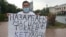 Kazakhstan - Erbolat Turkeev is holding a banner with the slogan against the authority. Almaty, 18 August 2020