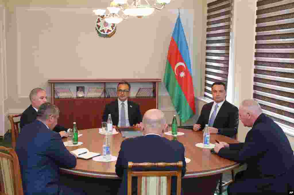 Representatives of Nagorno-Karabakh, Azerbaijan's government, and the Russian peacekeeping contingent are seen at "reintegration" talks in Yevlax on September 21. The talks ended with no public statements nor any sign of a breakthrough. The talks followed Azerbaijani President Ilham Aliyev's boast to his oil- and gas-rich nation of 10 million after a Russian-brokered cease-fire halted intense fighting on September 20 that he said had "restored its sovereignty." The meeting came as part of the truce for what the Azerbaijani side calls talks on "reintegration" of the territory into the rest of the country after decades of occupation.