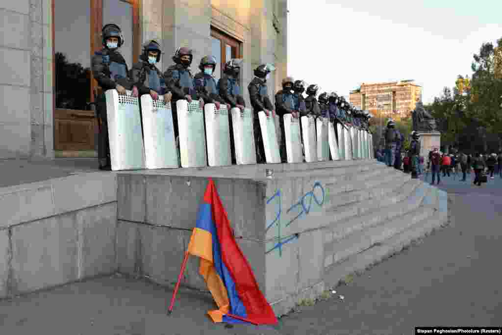 Law enforcement officers guard a building during the protests.