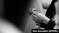 Кыргызстандын аялдар түрмөсүндө байпак токуп отурган аял.