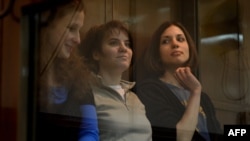 Pussy Riot defendants Yekaterina Samutsevich, Maria Alyokhina, and Nadezhda Tolokonnikova (left to right) sit in the dock during their appeal hearing in Moscow on October 1.