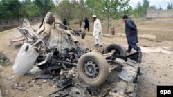 FILE: Security officials inspect the vehicle of a tribal who was killed when his vehicle was hit by a roadside bomb in Bajaur district in November 2015.