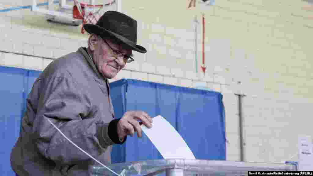 A man casts his ballot at a polling station in Kyiv on April 21.