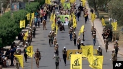 راهپیمایی نیروهای گروه «سرایا الخراسانی»، از گروه‌های وابسته به جمهوری اسلامی، در بغداد، ۲۰۱۸