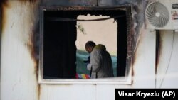 Një punëtor i forenzikës inspekton spitalin që u dogj në Tetovë të Maqedonisë së Veriut. 