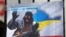 Плакат із зображенням президента Росії Володимира Путіна під час акції «Крим – це Україна» біля російського посольства в Києві, 16 березня 2020 року