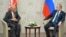 FILE: Russian President Vladimir Putin (R) with Afghan President Ashraf Ghani of Afghanistan, July 2015.