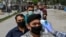 A health worker checks the body temperature of worshippers as a preventive measure against the COVID-19 before the Friday prayers on the first day of the Muslim holy month of Ramadan at Wazir Akbar Khan mosque in Kabul on April 24.
