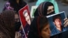 Relatives hold portraits of disappeared family members during a protest in Karachi in August.