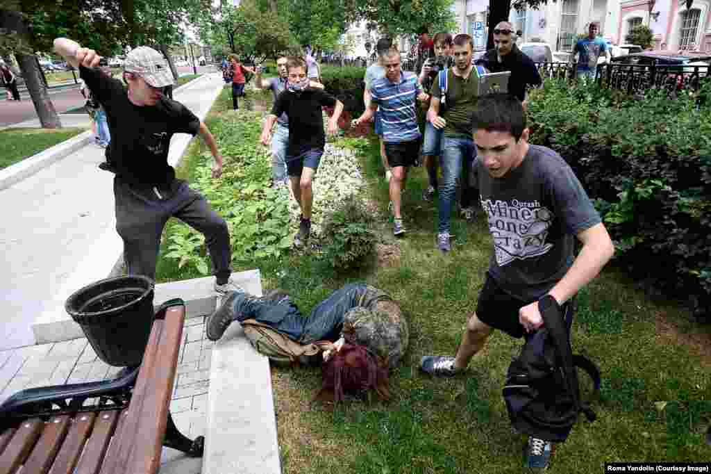 Another participant in the protest against the "gay propaganda" ban being attacked by youths in Moscow. Despite Putin's public statements,&nbsp;activists say the law he signed prohibiting the spread of gay "propaganda" among minors has encouraged discrimination and violence.&nbsp;Putin has also been criticized for bolstering the careers of homophobic&nbsp;public figures.&nbsp;