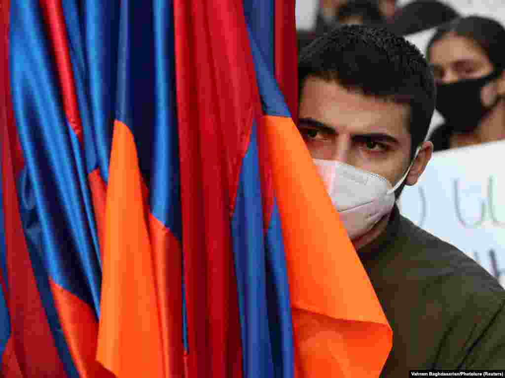 A demonstrator holds national flags during the opposition rally.