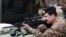 FILE: Raheel Sharif trying a rifle during his visit to the Pakistan Ordnance Factories in April 2015.